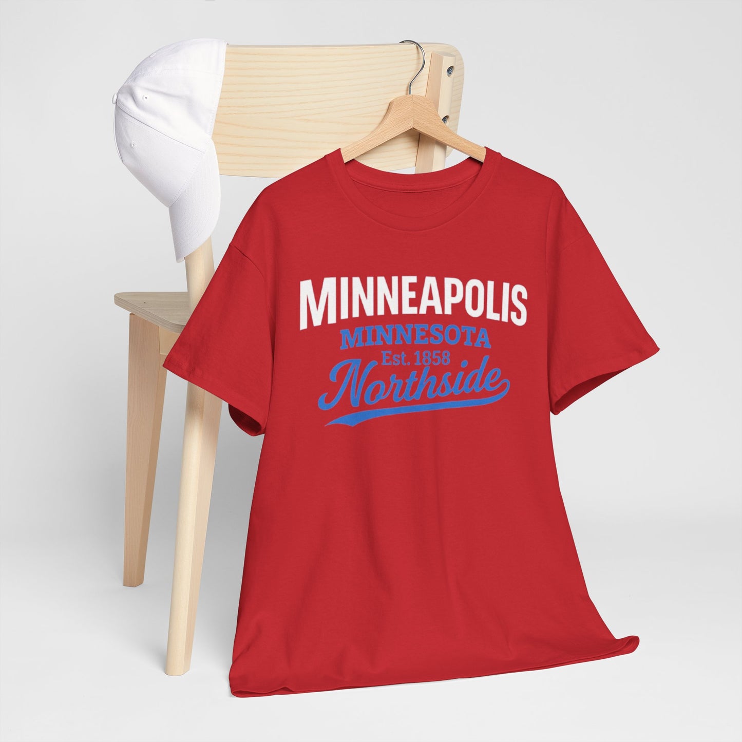 Red t-shirt with 'Minneapolis Minnesota Northside' text on a wooden chair against a white background
