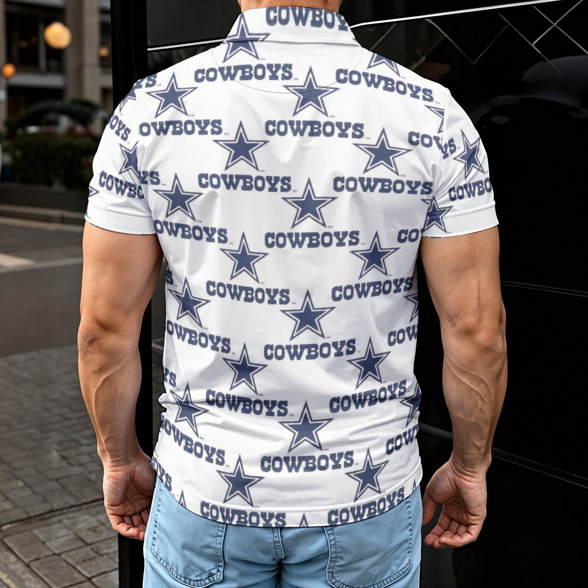 Person wearing a white shirt with 'Cowboys' and star pattern, standing outdoors.