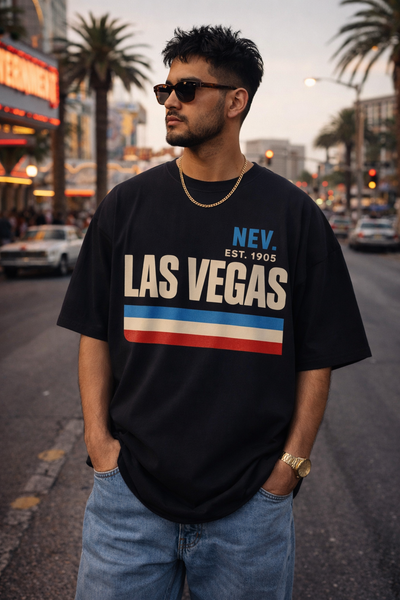 Man wearing a black 'Las Vegas' t-shirt on a city street.