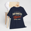 Navy blue t-shirt with 'San Francisco' text on a wooden chair against a white background