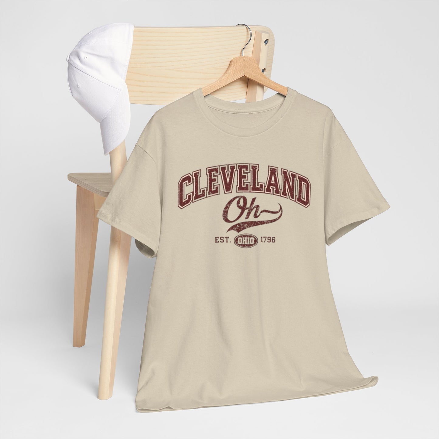 Beige t-shirt with 'Cleveland Oh' text on a hanger against a white background