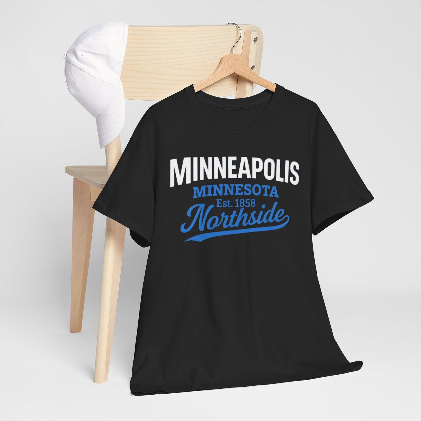 Navy blue t-shirt with 'Minneapolis Minnesota Est. 1858 Northside' text on a wooden chair.