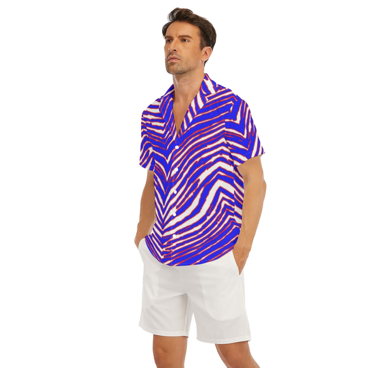 Man wearing a colorful patterned shirt and white shorts on a white background