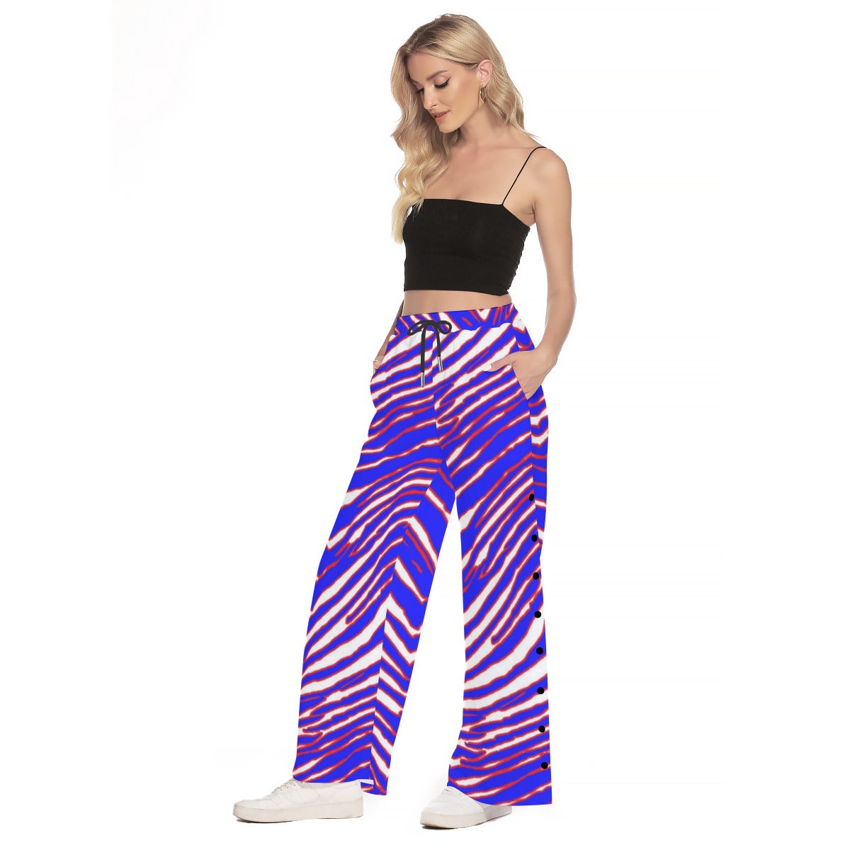 Woman wearing colorful chevron-patterned pants on a white background