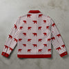 Red and white striped shirt with red bear pattern on a gray surface