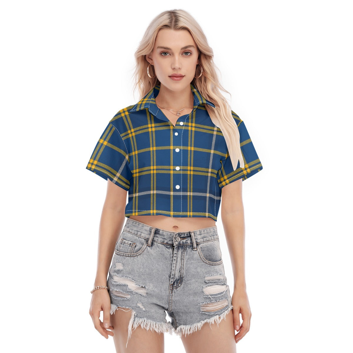 Woman wearing a blue and yellow plaid shirt with ripped denim shorts on a white background