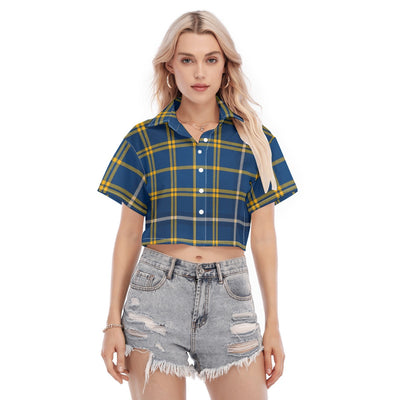 Woman wearing a blue and yellow plaid shirt with ripped denim shorts on a white background