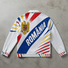 White jacket with colorful design and 'ROMÒNIA' text on a concrete surface