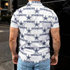 Person wearing a white shirt with 'Cowboys' and star pattern, standing outdoors.