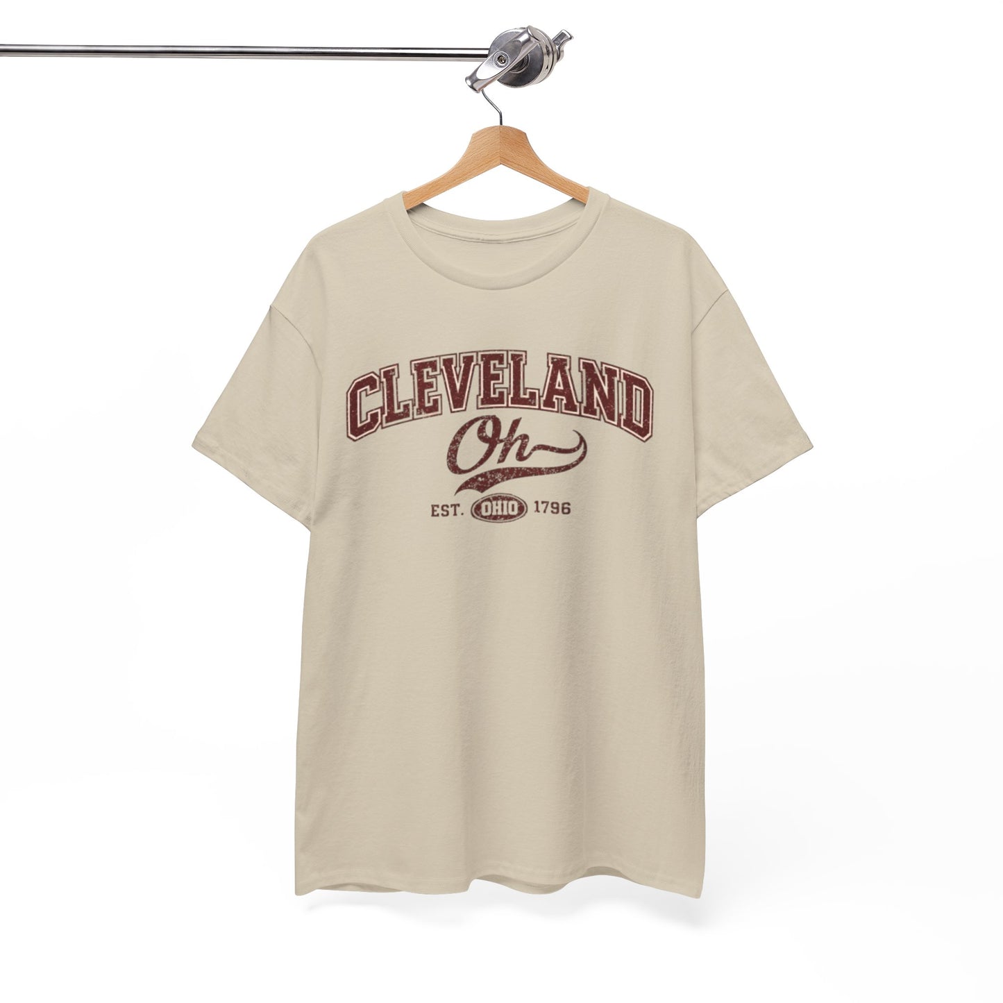 Beige t-shirt with 'Cleveland Oh' text on a hanger against a white background