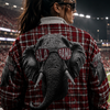 Person wearing a plaid jacket with elephant design at a sports stadium