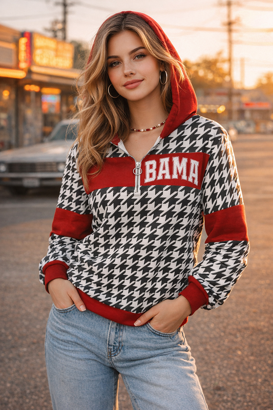 Woman wearing a houndstooth patterned hoodie with 'BAMA' text in an urban setting.