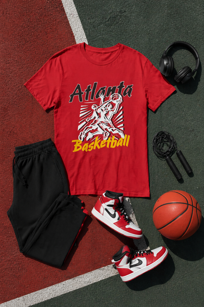 Red t-shirt with 'Atlanta Basketball' design on a basketball court, surrounded by black shorts, red sneakers, jump rope, and basketball.