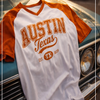 White and orange 'Austin, Texas' t-shirt on a classic car