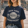 Woman wearing a navy blue t-shirt with 'New York Baseball Championship' text on a city street.