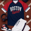 Baseball-themed clothing and accessories including a jersey, shorts, shoes, and cap on a baseball field background.