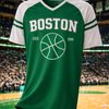 Green and white sports jersey with 'Boston' and basketball design on a hanger against a sports arena background.