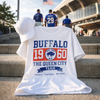 White t-shirt with 'Buffalo 1960' design on steps with people in the background