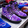 Zebra-patterned boots with Buffalo Bills logo on a sports-themed surface