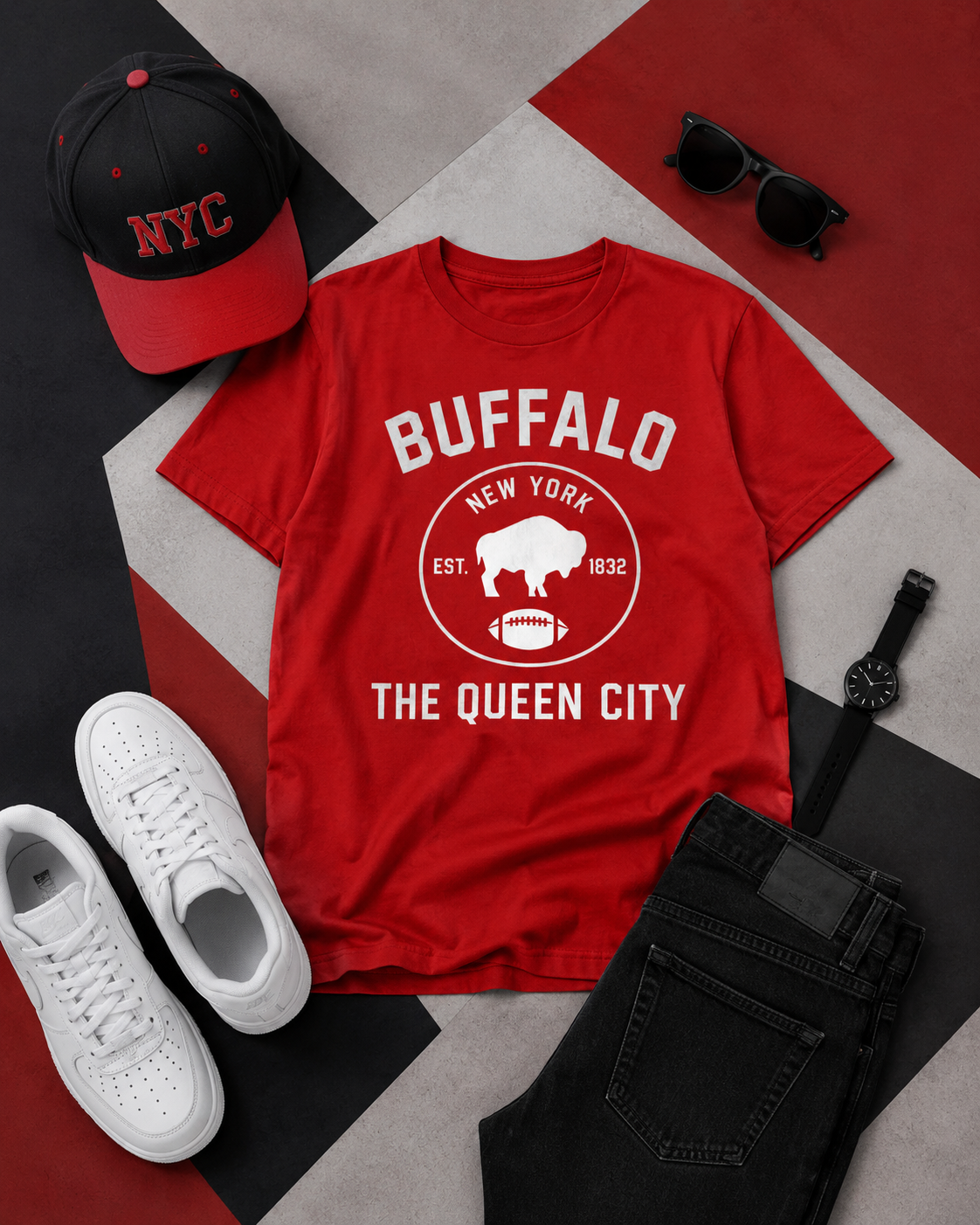 Red t-shirt with 'Buffalo New York' design, black cap, white sneakers, sunglasses, and black watch on a geometric patterned surface.