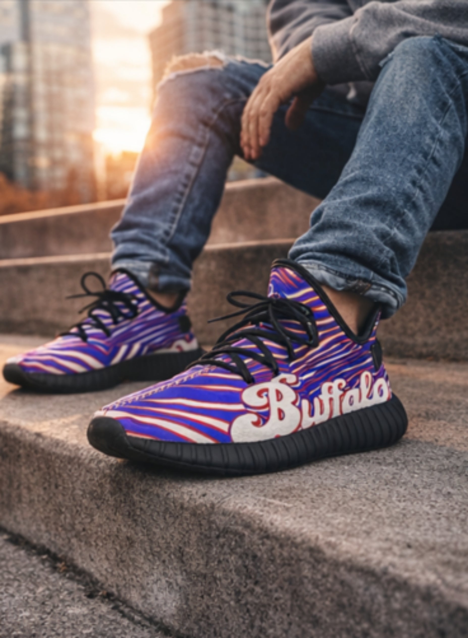 Person wearing colorful sneakers with 'Buffalo' branding on a concrete step.