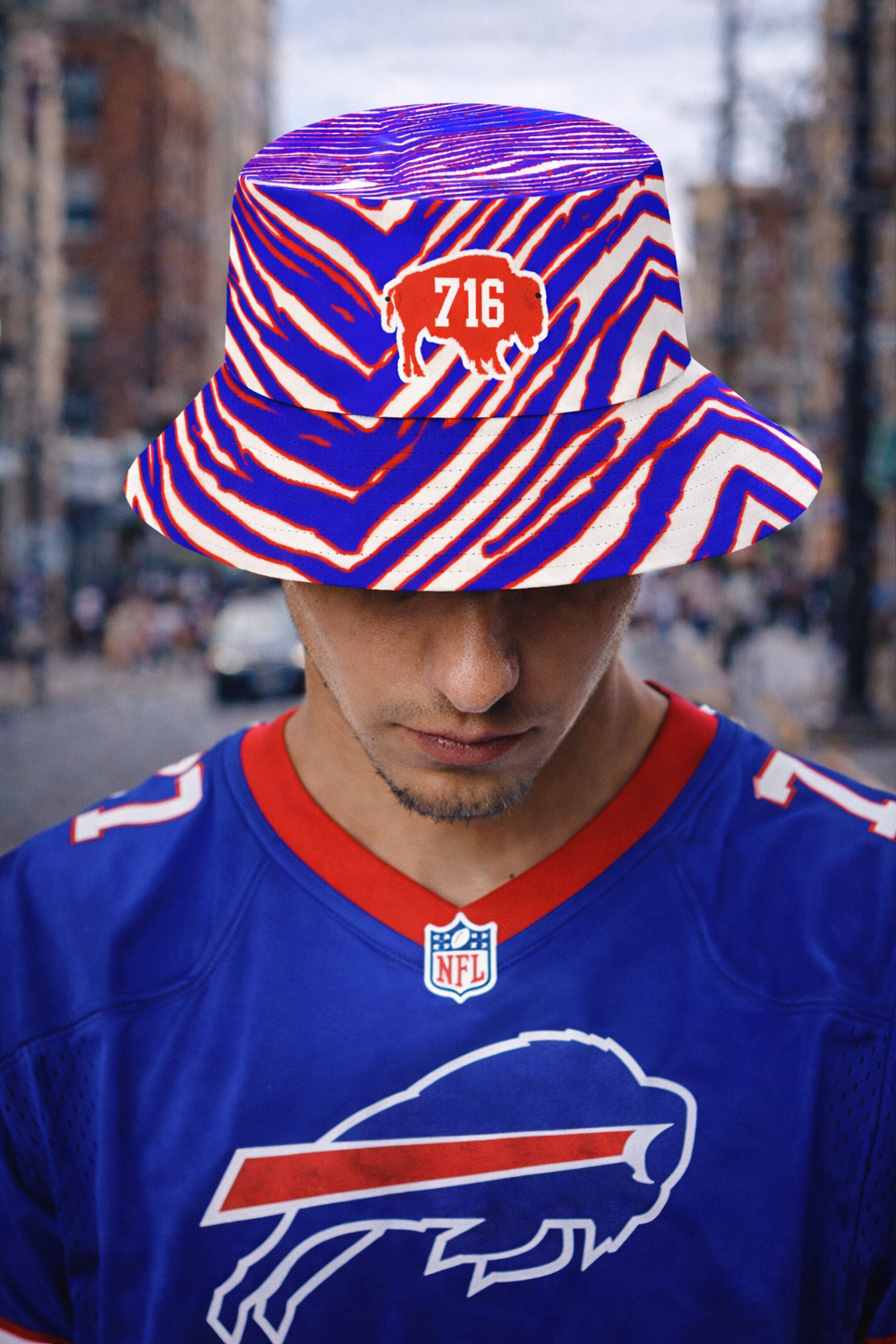 Person wearing a colorful bucket hat and a blue sports jersey with a logo.