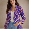 Woman wearing a colorful blazer with a neutral background