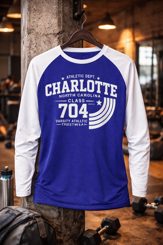 Blue and white long-sleeve shirt with 'Charlotte' text on a hanger in an indoor setting.