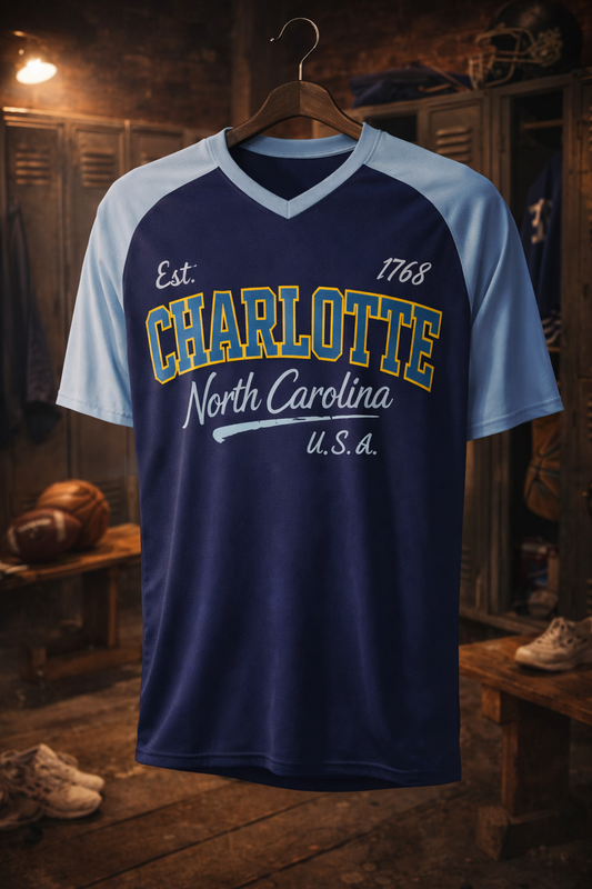 Navy and light blue sports jersey with 'Charlotte North Carolina U.S.A.' text on a wooden locker room background.
