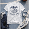 White t-shirt with 'Chicago Athletic Dept.' design on a basketball court with shorts, sneakers, and a ball.