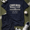 Navy blue t-shirt with 'Chicago Baseball Club' text, shorts, sneakers, and a baseball on grass.