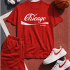 Red 'Chicago Illinois' t-shirt with shorts, sneakers, and a basketball on a sports court.