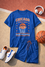 Blue 'Chicago Street Ball South Side Rebels' t-shirt with shorts, sneakers, and basketball on a textured surface.