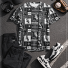 Black and white sports-themed outfit with t-shirt, shorts, sneakers, and accessories on a textured surface.