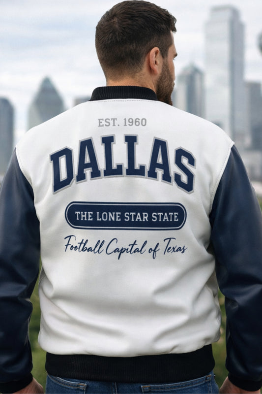 Man wearing a white and blue letterman jacket with 'Dallas' and city description text, standing against a cityscape.