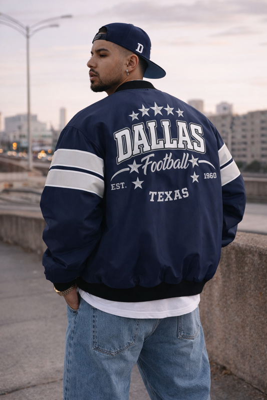 Person wearing a navy 'Dallas Football Texas' jacket with a cityscape background