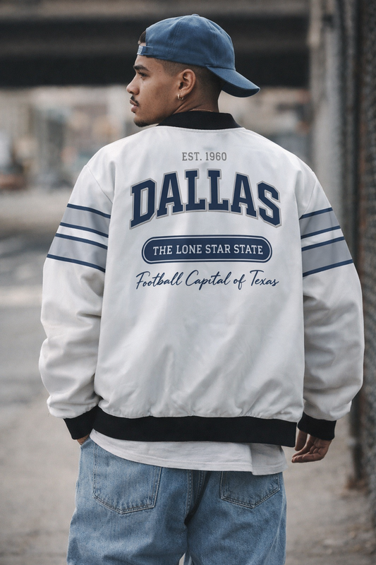 Person wearing a white jacket with 'Dallas' text, standing outdoors.