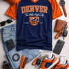Collection of Denver-themed clothing and accessories including a t-shirt, cap, shoes, and jeans on a light gray background.