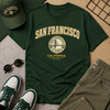 Green t-shirt with 'San Francisco California' design, green cap, sunglasses, and green shoes on a neutral background.