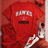 Red 'Hawks Illinois' t-shirt, shorts, sneakers, and basketball on a red textured background