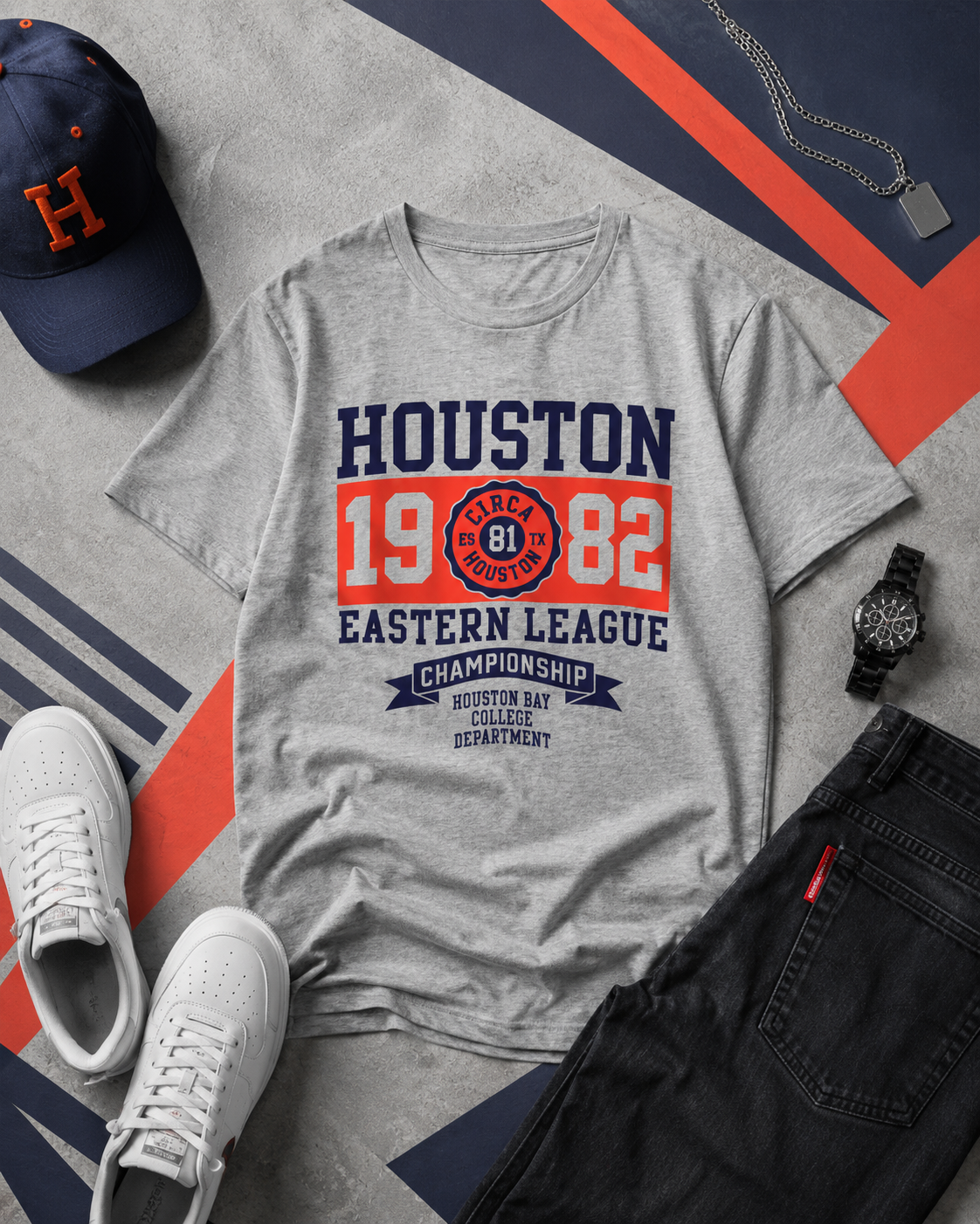 Gray t-shirt with 'Houston' text and sports-themed design, surrounded by a cap, sneakers, and watch on a patterned surface.