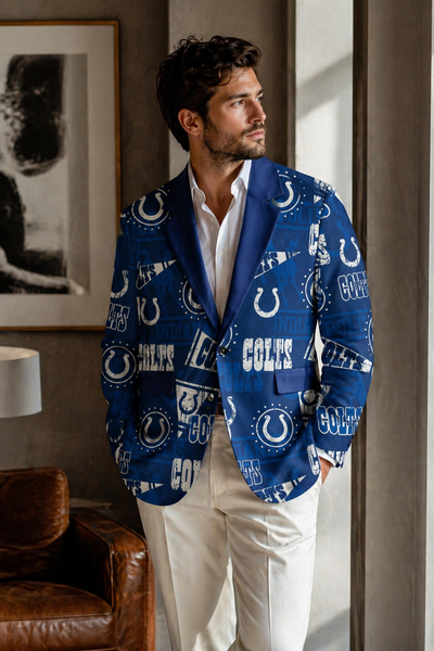 Man wearing a blue sports team blazer with logos in an indoor setting