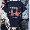 Navy t-shirt with 'Los Angeles' text, cap, sneakers, and accessories on a light gray background