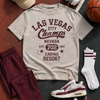 T-shirt with 'Las Vegas City Champs' design, maroon pants, white sneakers, cap, socks, and basketball on a dark surface.