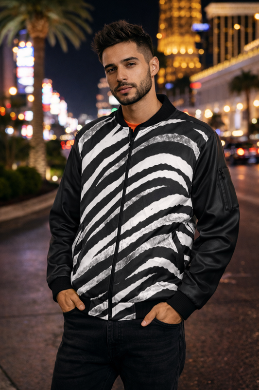 Man wearing a zebra-striped jacket on a city street at night.