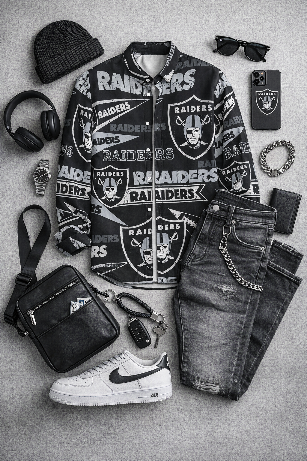 Collection of Oakland Raiders-themed clothing and accessories on a gray surface