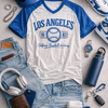 Los Angeles-themed clothing and accessories including a t-shirt, jeans, sneakers, and hat.