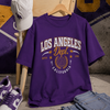 Purple t-shirt with 'Los Angeles Dept' design, white cap, purple sneakers, sunglasses, and jeans on a textured background.