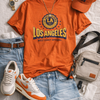 Orange 'Los Angeles' t-shirt with casual outfit on a light gray surface
