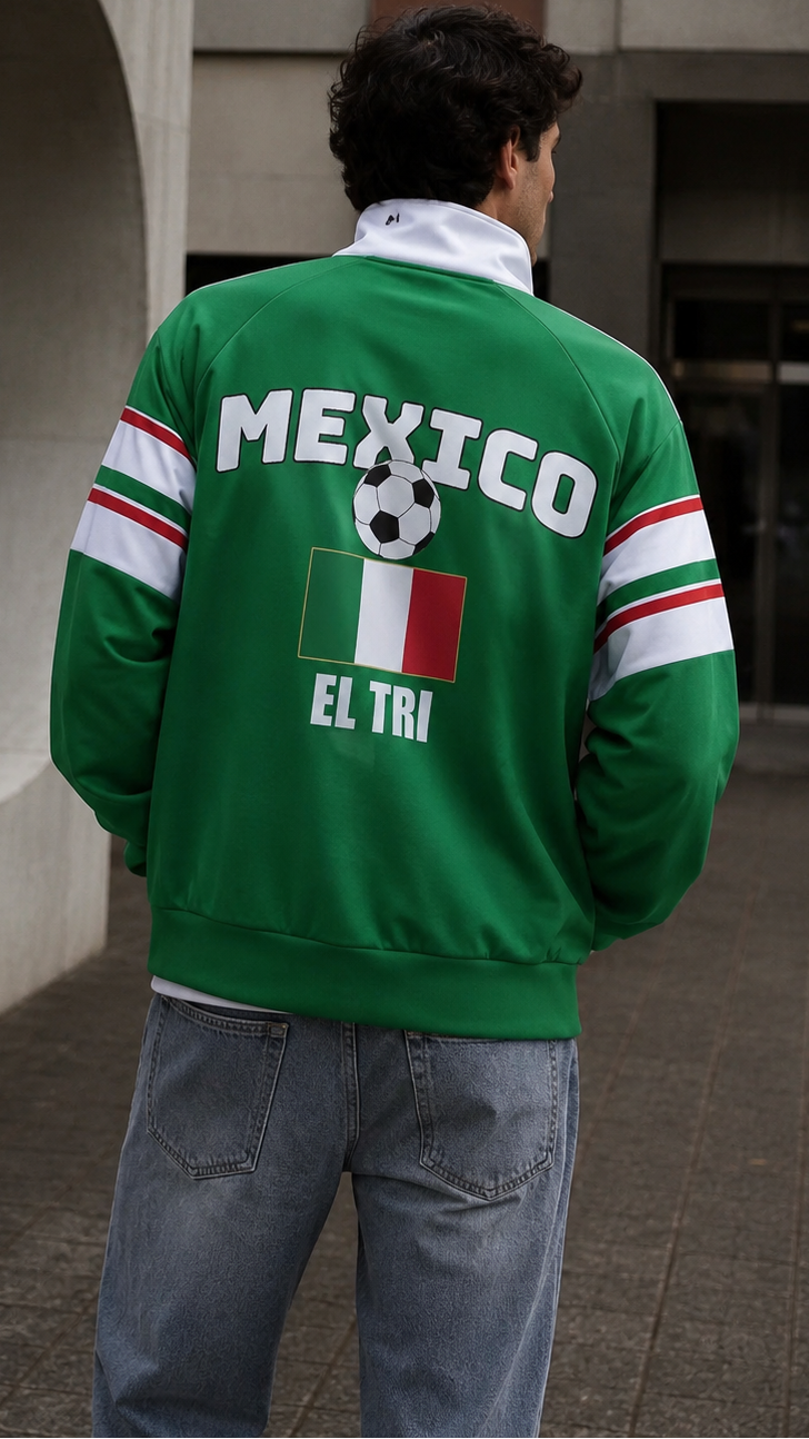 Person wearing a green Mexico-themed jacket with soccer design outdoors.